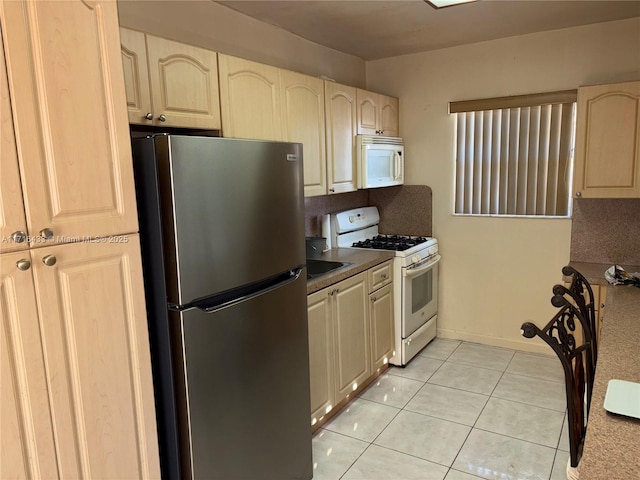 kitchen with white appliances and light tile patterned floors