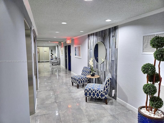 hallway with ornamental molding and a textured ceiling