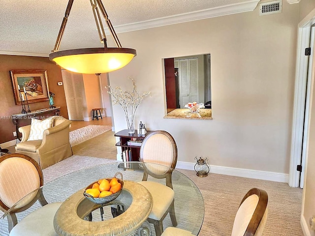 dining room with a textured ceiling and ornamental molding