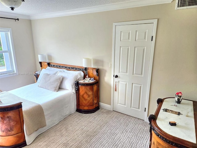 carpeted bedroom featuring ornamental molding and a textured ceiling