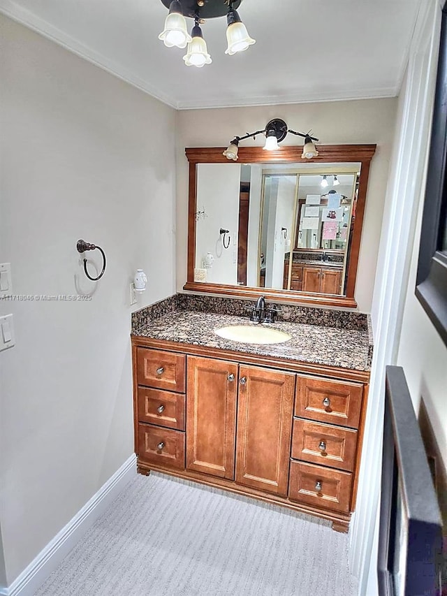 bathroom with vanity and ornamental molding