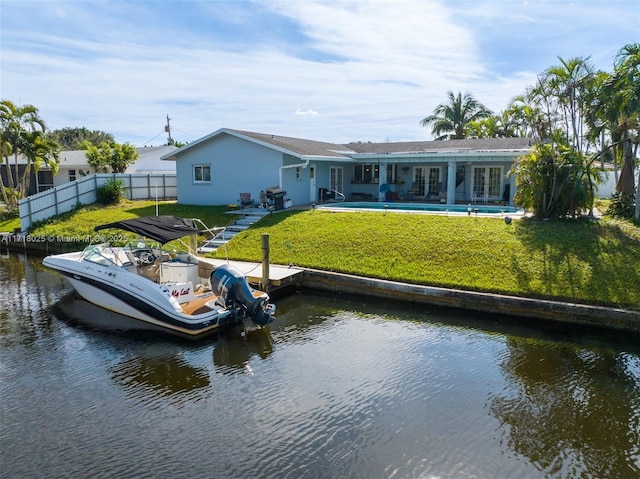 exterior space featuring a water view and a lawn