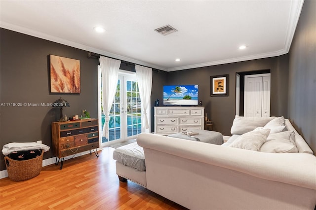 living room featuring french doors, hardwood / wood-style flooring, and ornamental molding