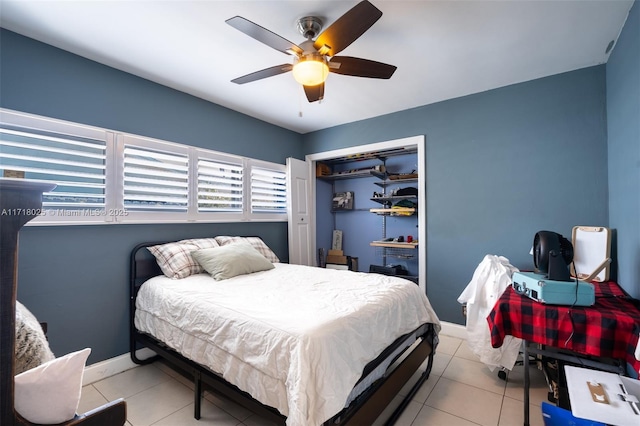 bedroom featuring light tile patterned floors, a closet, and ceiling fan