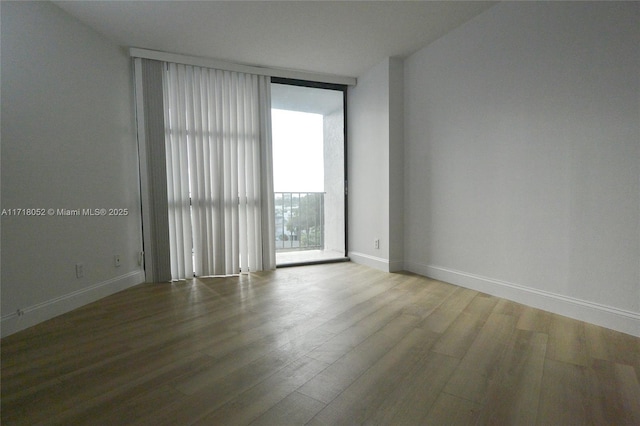 empty room with hardwood / wood-style floors