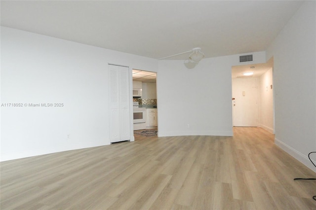 spare room with light hardwood / wood-style flooring