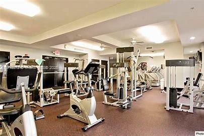 gym with a tray ceiling