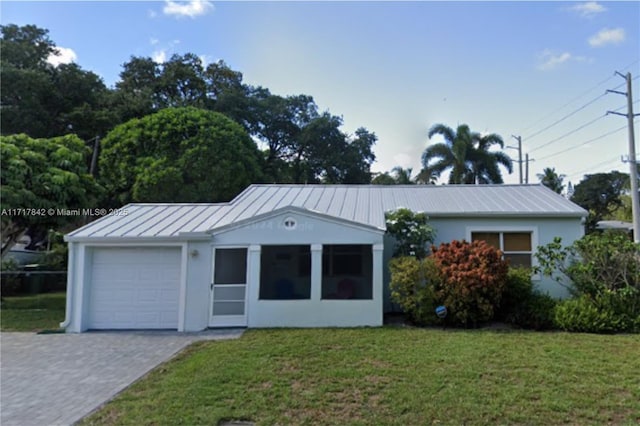 view of front of house with a front yard and a garage