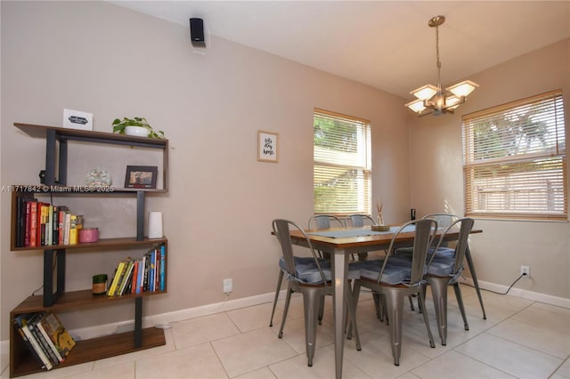 tiled dining area featuring a notable chandelier