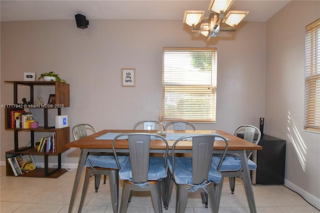 dining area featuring light tile patterned floors and a chandelier