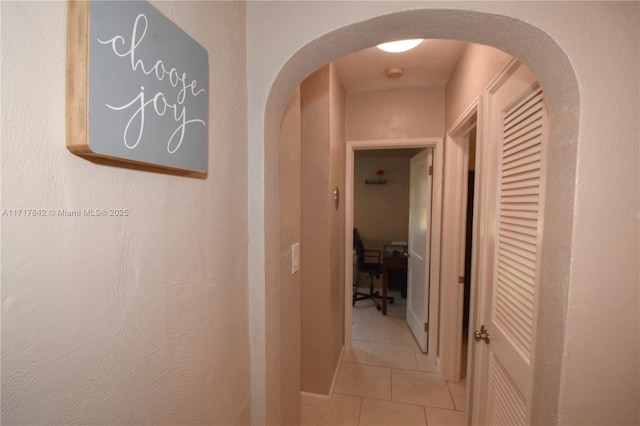 hall featuring light tile patterned floors