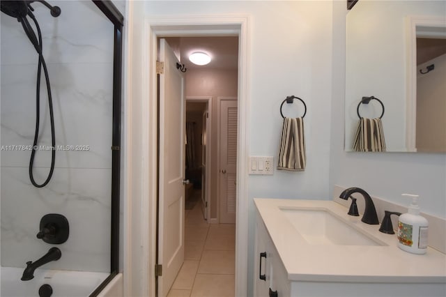 bathroom with shower / bath combination with glass door, vanity, and tile patterned flooring