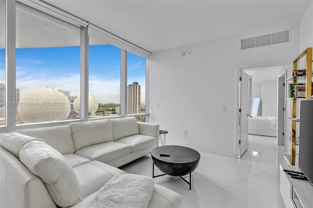 living room with light tile patterned floors and floor to ceiling windows