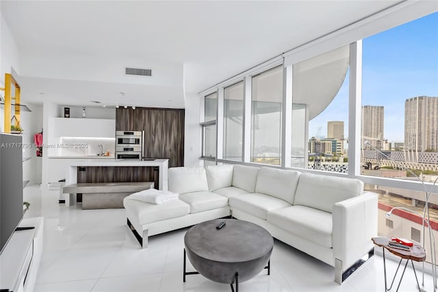 living room featuring a view of city, light tile patterned flooring, and visible vents