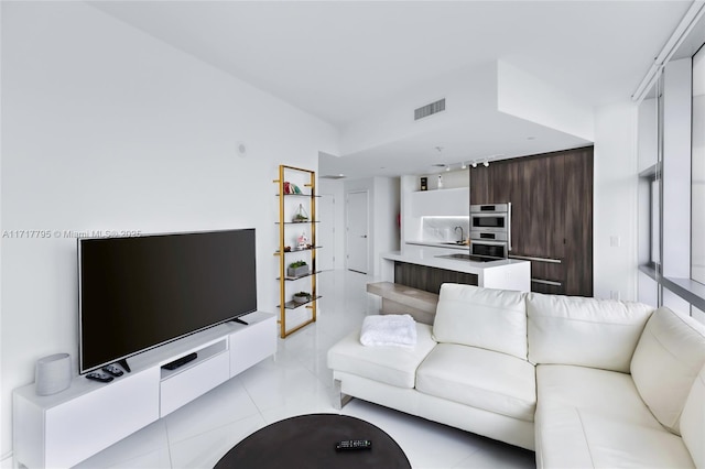 living room with visible vents and light tile patterned flooring