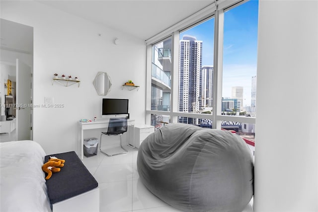 tiled living room featuring a wall of windows