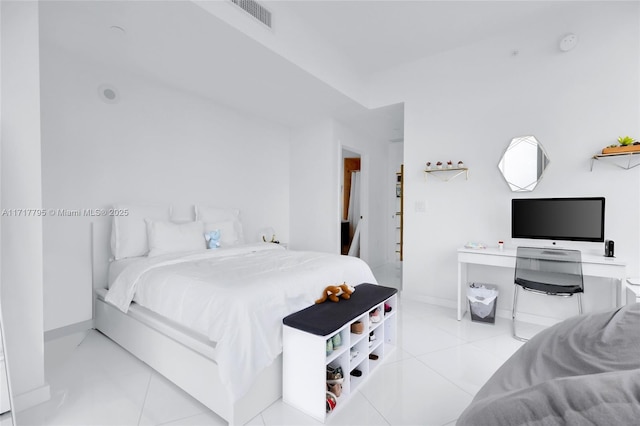 tiled bedroom with visible vents and baseboards