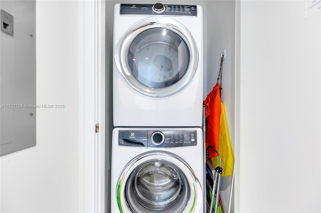 washroom with stacked washer and dryer and laundry area