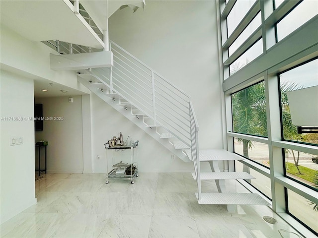 staircase with a high ceiling