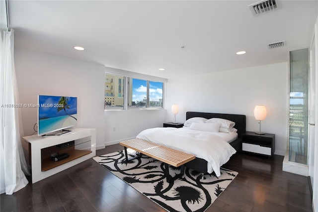 bedroom with dark hardwood / wood-style flooring