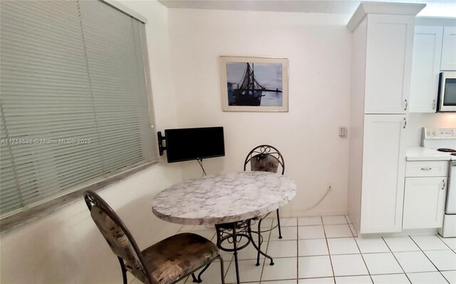 dining space featuring a textured ceiling and light tile patterned floors