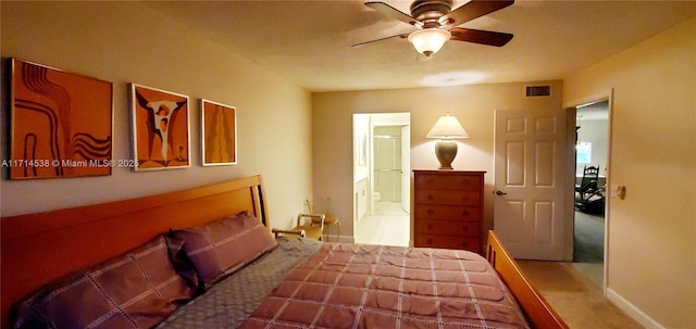 bedroom featuring visible vents, a ceiling fan, and ensuite bathroom