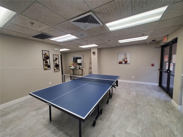 playroom with a paneled ceiling