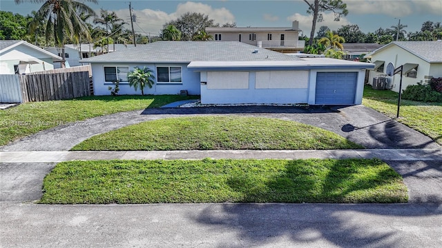 view of front of home with a front yard and a garage