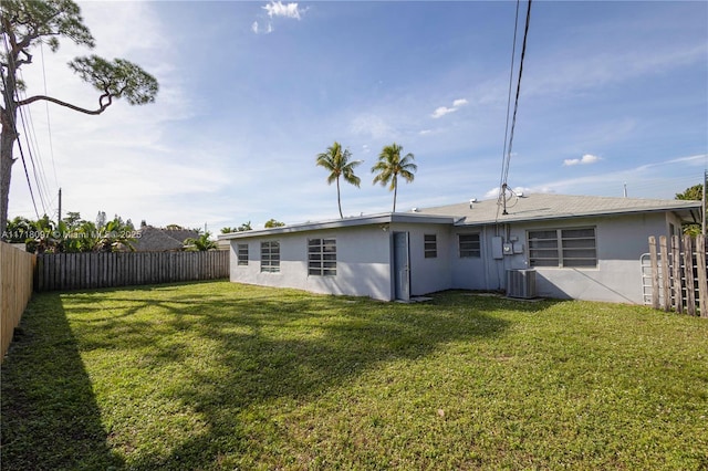 back of property featuring a yard and cooling unit