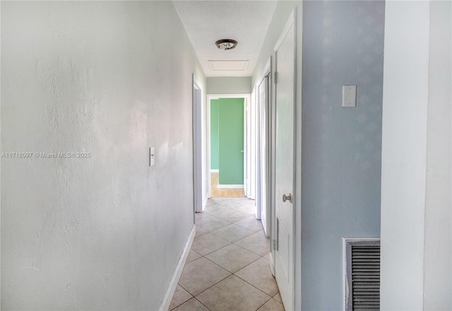 hall featuring light tile patterned floors