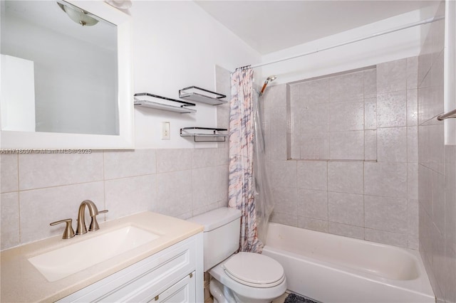 full bathroom with vanity, toilet, tile walls, and shower / tub combo