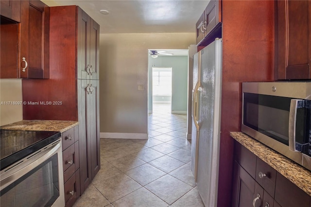 kitchen featuring ceiling fan, electric range oven, light stone counters, white refrigerator with ice dispenser, and light tile patterned floors