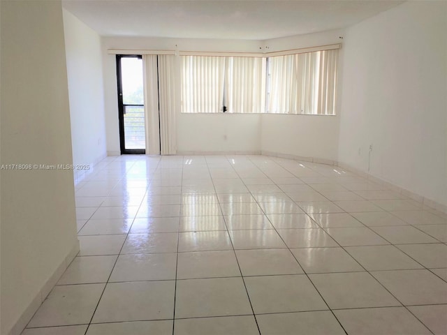 unfurnished room featuring light tile patterned floors