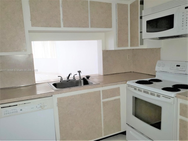 kitchen featuring white appliances and sink