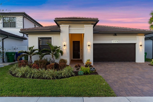 view of front of house featuring a yard and a garage