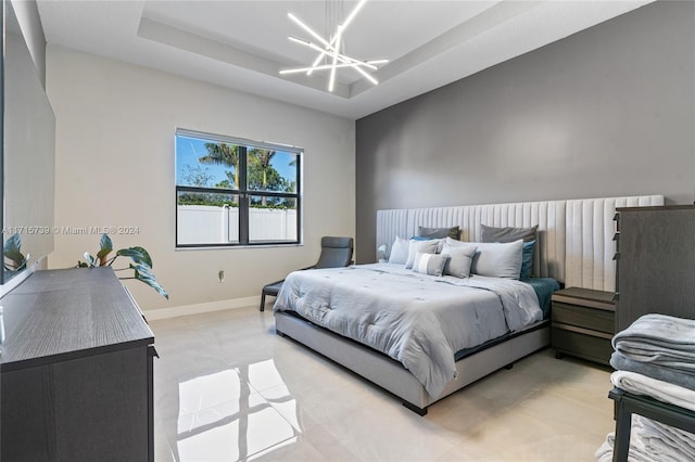 bedroom featuring a chandelier and a raised ceiling