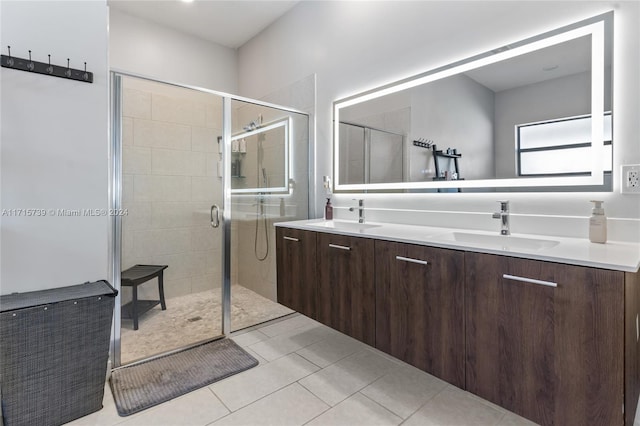 bathroom with tile patterned flooring, vanity, and walk in shower