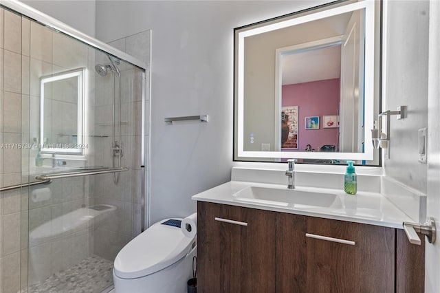 bathroom featuring vanity, toilet, and an enclosed shower