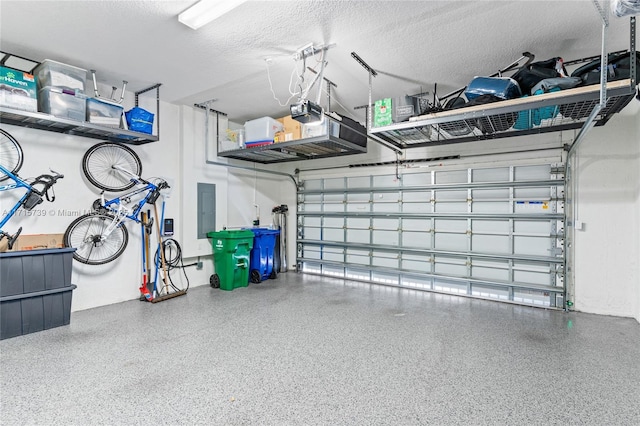 garage featuring electric panel and a garage door opener