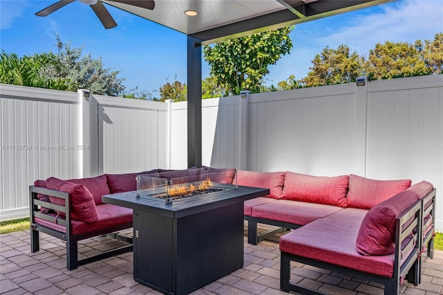 view of patio / terrace featuring ceiling fan and an outdoor fire pit