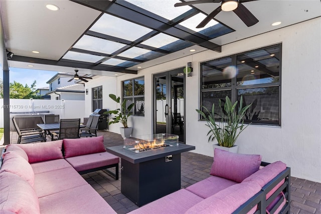 view of patio featuring french doors and an outdoor living space with a fire pit