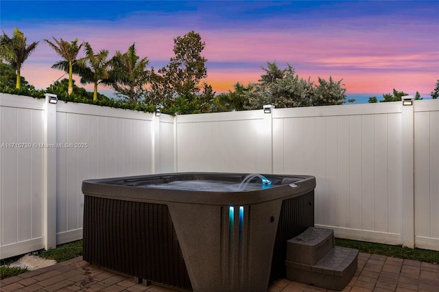 patio terrace at dusk with a hot tub