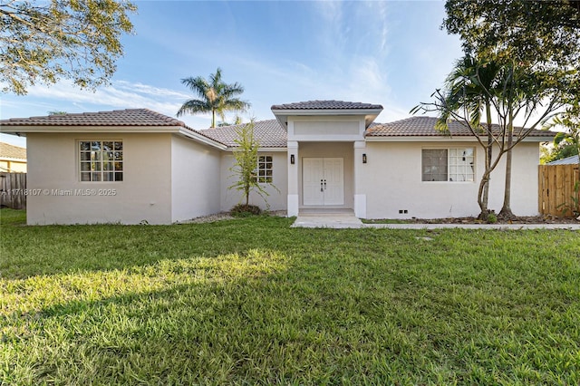 mediterranean / spanish-style house featuring a front lawn