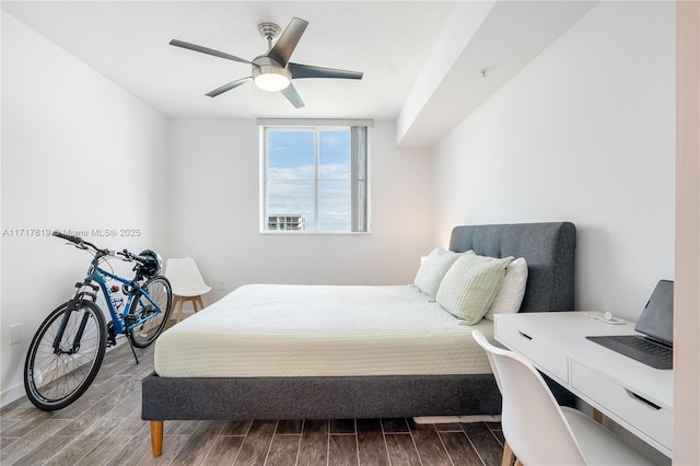 bedroom featuring wood tiled floor and a ceiling fan