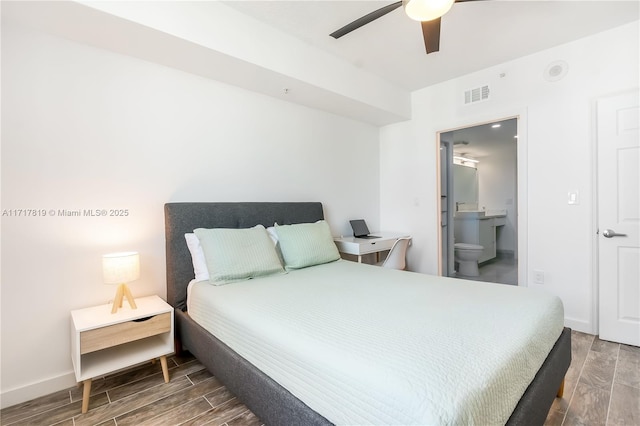 bedroom with baseboards, visible vents, and wood finish floors