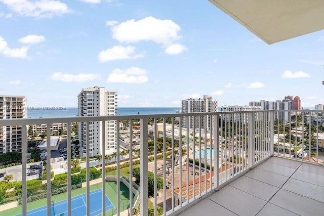 balcony with a water view and a view of city