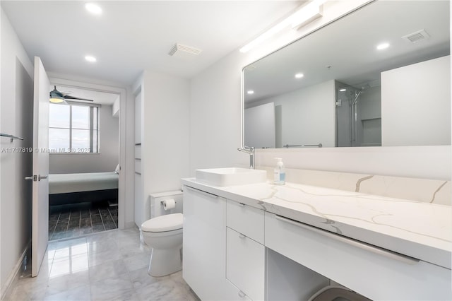 bathroom with toilet, walk in shower, and vanity