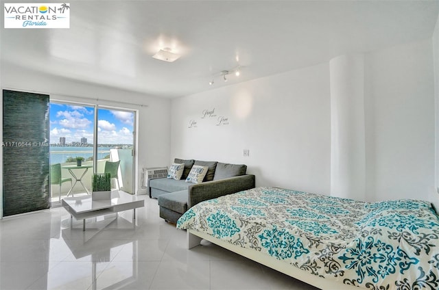 bedroom featuring access to exterior and light tile patterned floors