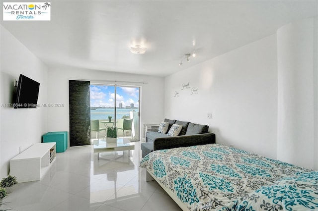 tiled bedroom featuring a water view