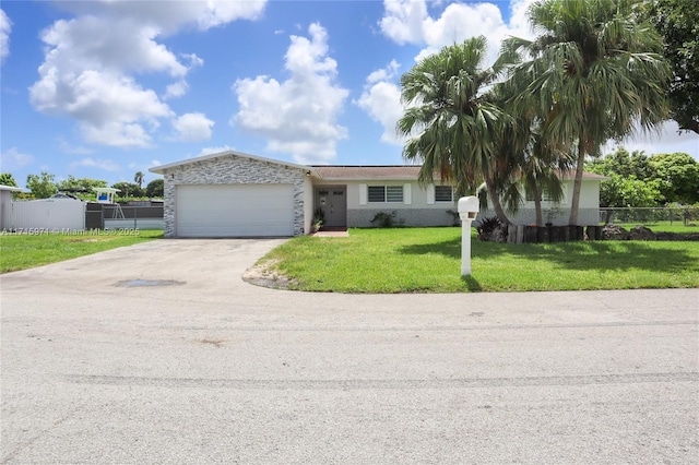 single story home with a front yard and a garage